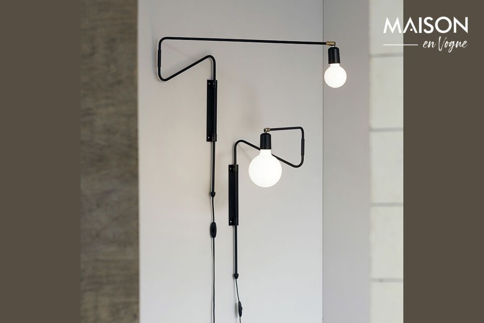 Explore functional elegance with the Swing black brass wall sconce and spotlight