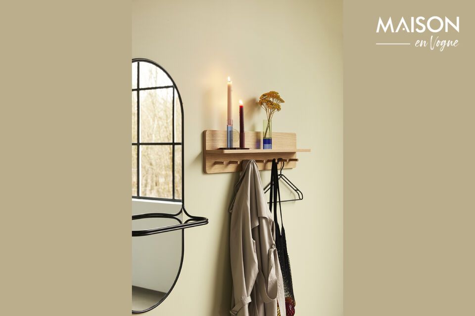 This wall mirror is not only a practical accessory for hanging towels or plaids