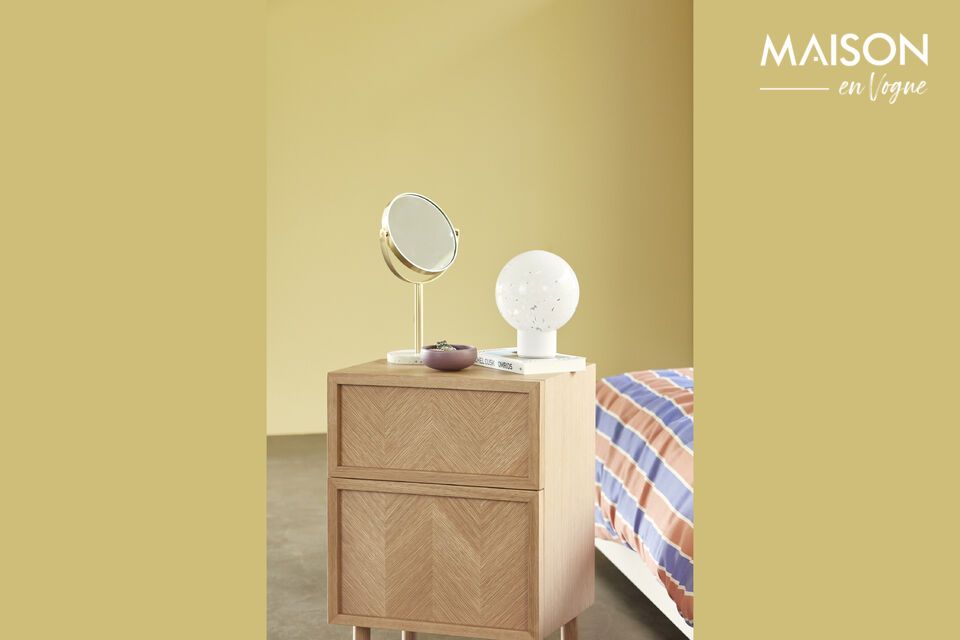 The Herringbone light oak bedside table brings a touch of elegance and functionality to your bedroom