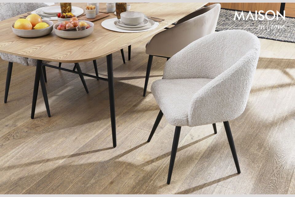 Its slim yet sturdy metal frame harmoniously supports the spacious, natural tabletop