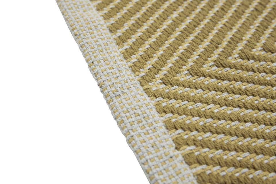 The Mellow mustard cotton rug adds a touch of warmth with its shades of mustard and sand