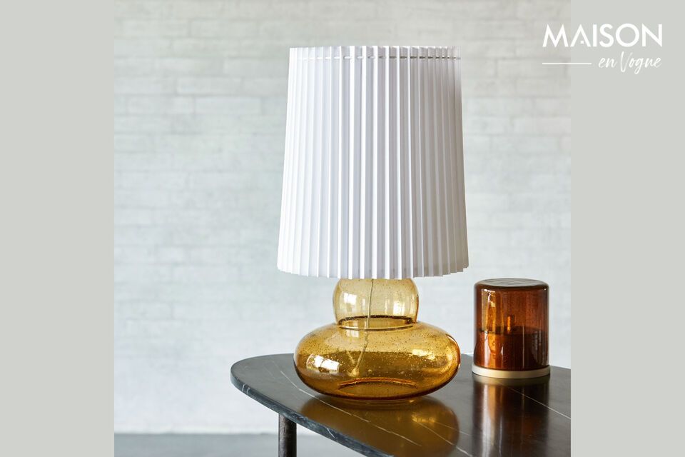 Bring warmth and elegance to your home with this amber glass lamp.