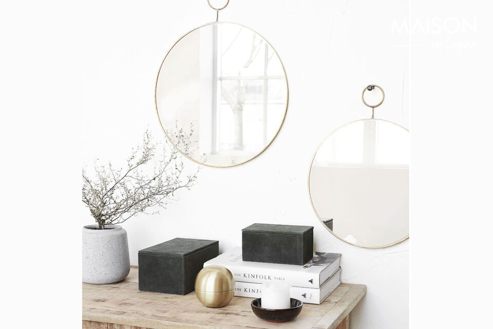 With its slim brass frame, this mirror boasts a sleek design that complements any modern decor